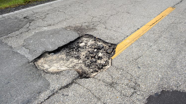 a pothole in the road demonstrating the worst highways for RVs